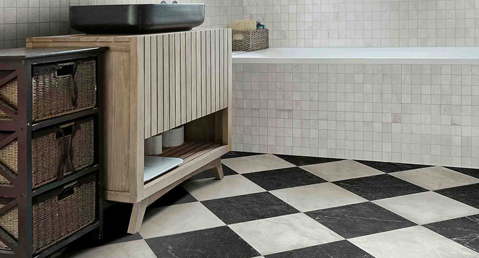 Bathroom floor with diamond arranged checkerboard black and white tiles.