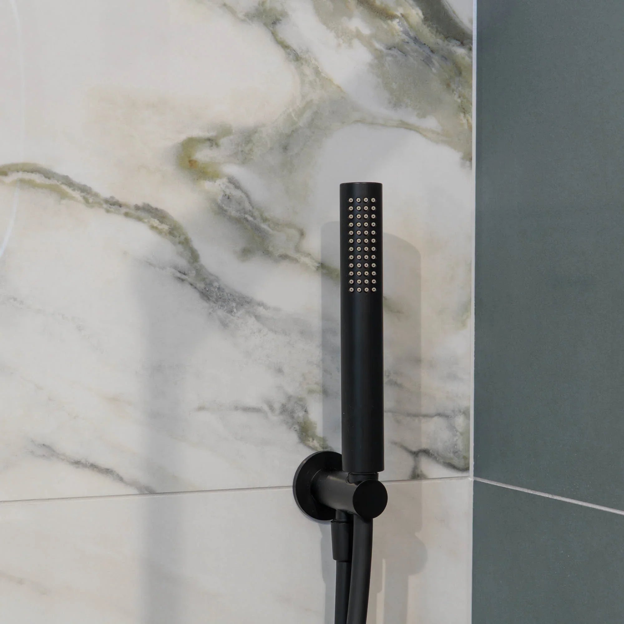 Portofino black shower head mounted on a marble wall deluxe bathrooms