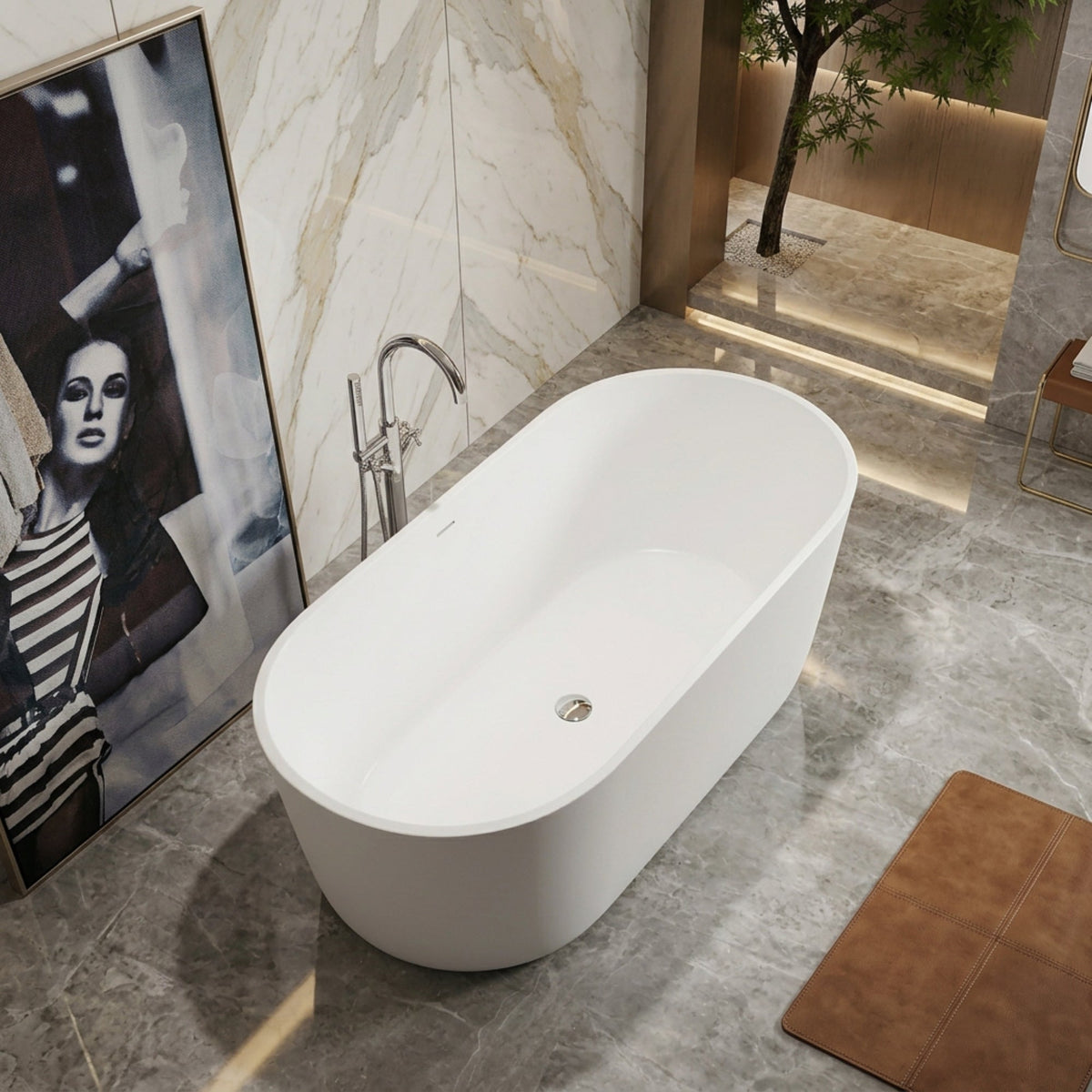 A modern freestanding oval bathtub in white, shown in a luxury bathroom setting with marble walls and gray stone flooring.