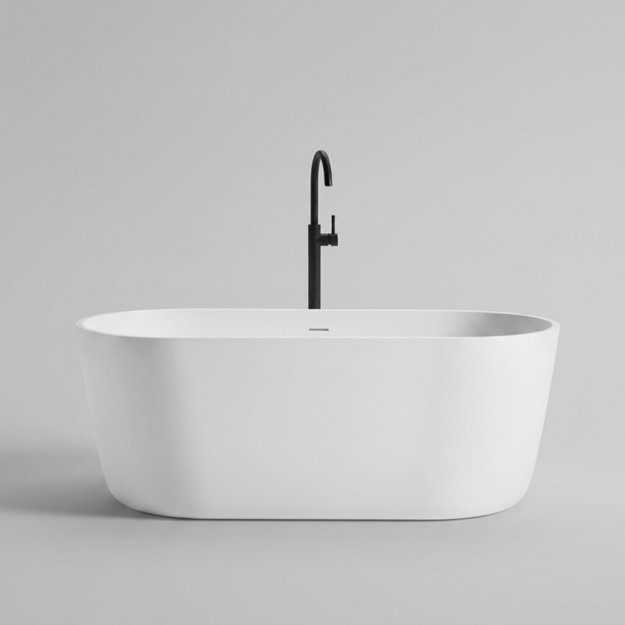A modern freestanding bathtub in matte white