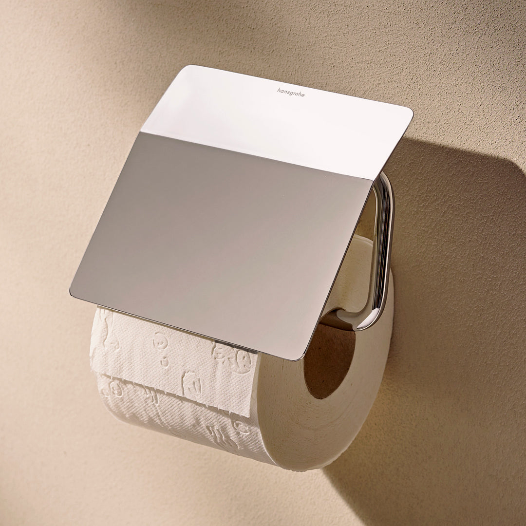 Photo of the Hansgrohe AddStoris S Toilet Roll Holder with Cover in chrome finish, with a toilet roll in place.